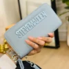 LL2829- CARTERA / MUÑEQUERA "STEVE MADDEN" DOBLE CIERRE. (1 PZA)