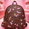 L-K279799 - MOCHILA DISEÑO PERSONAJES y CHERRY x "COACH" (1 PZA)